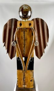 Angel of Repose is a striking piece. She invites you to review all of her custom elements of hand hewn wood, corrugated metal, local river rock