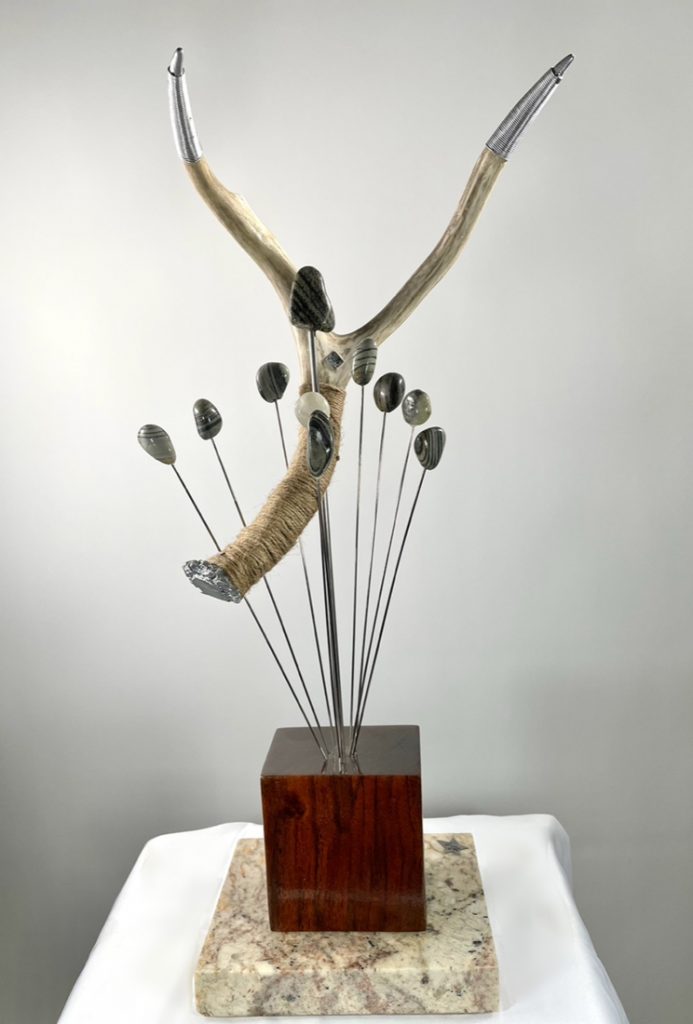 Why 10 Lives antler small river rock hanging in a bouquet together